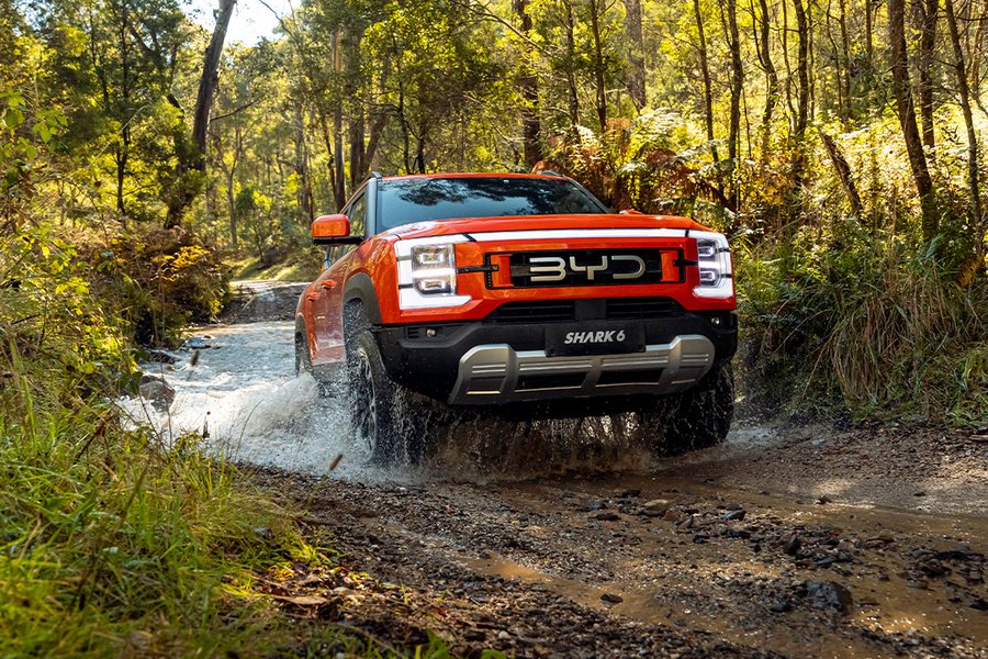BYD Shark 6 dual-cab ute driving through shallow water